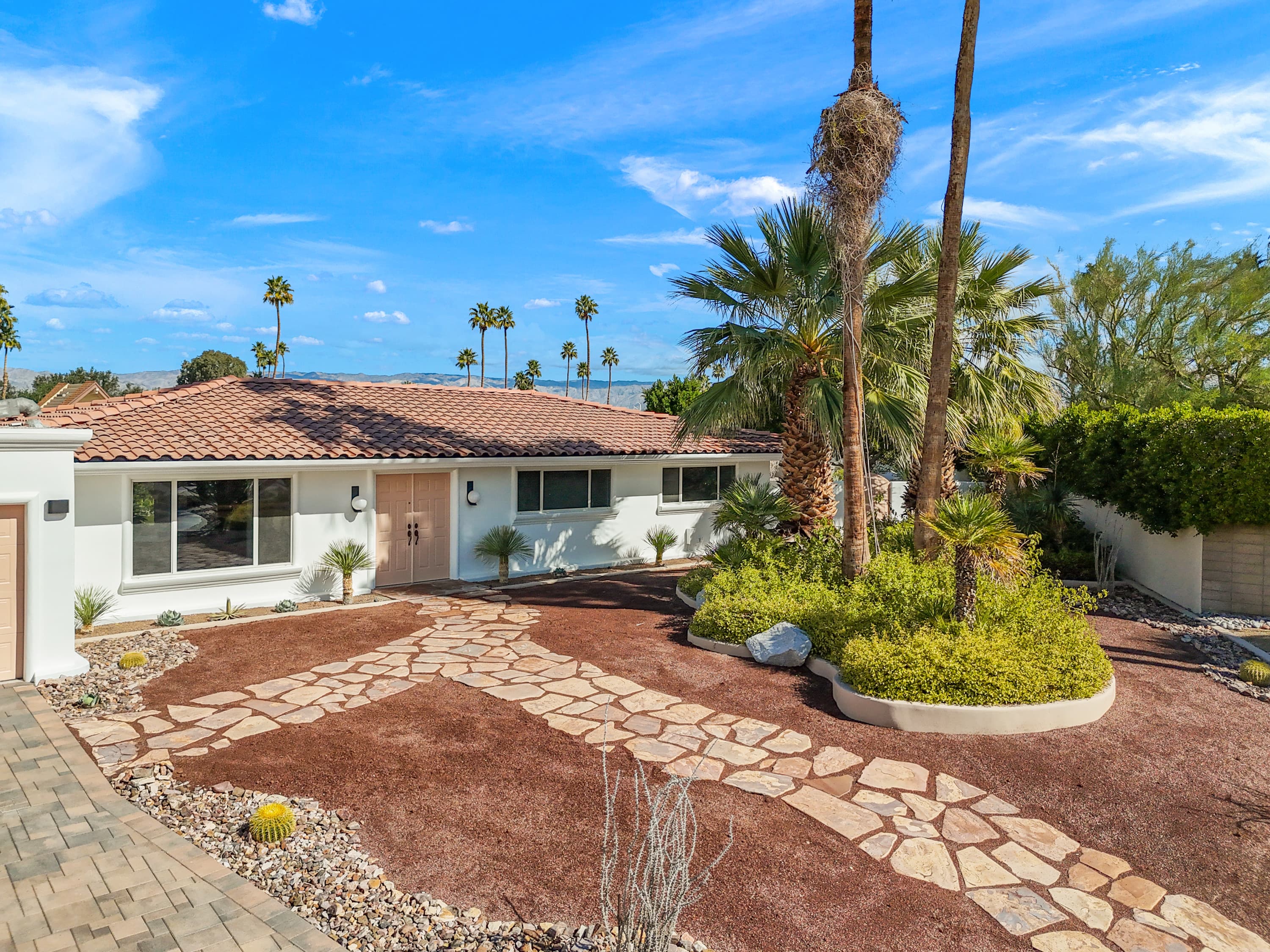 Front elevation with blush double doors and desert landscaping