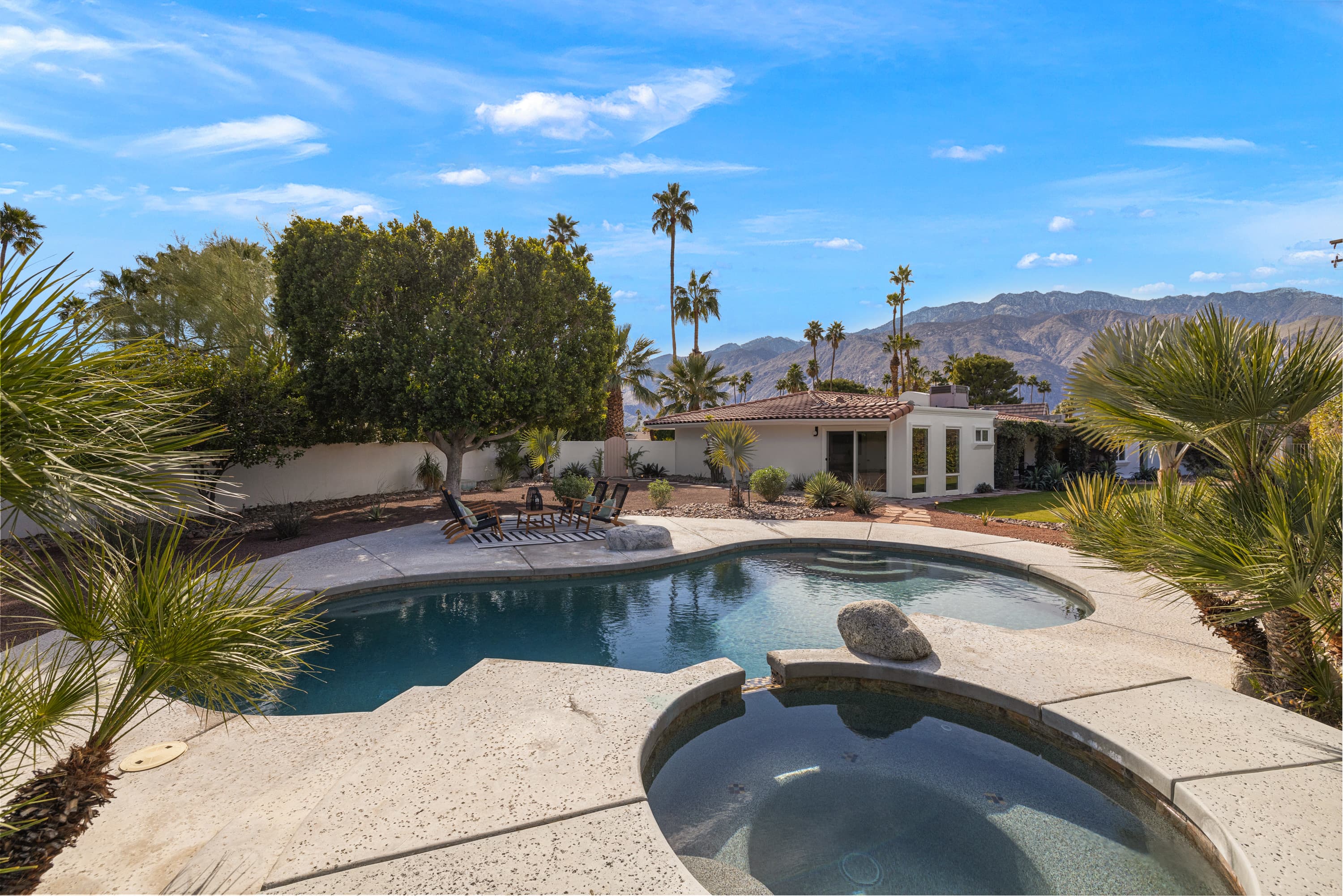 Elevated view of the pool and spa with mountain backdrop
