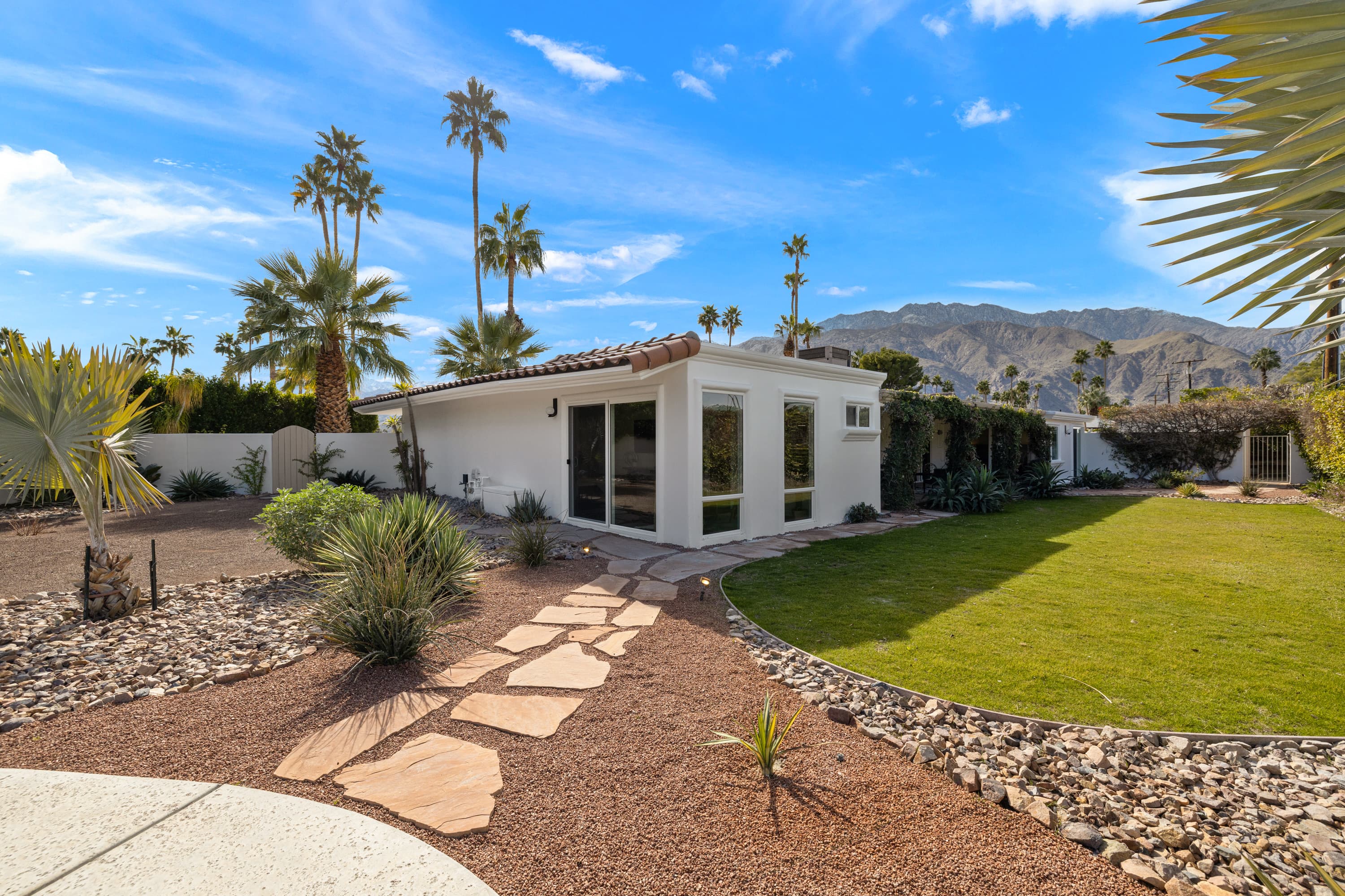 Backyard lawn with palms and mountains