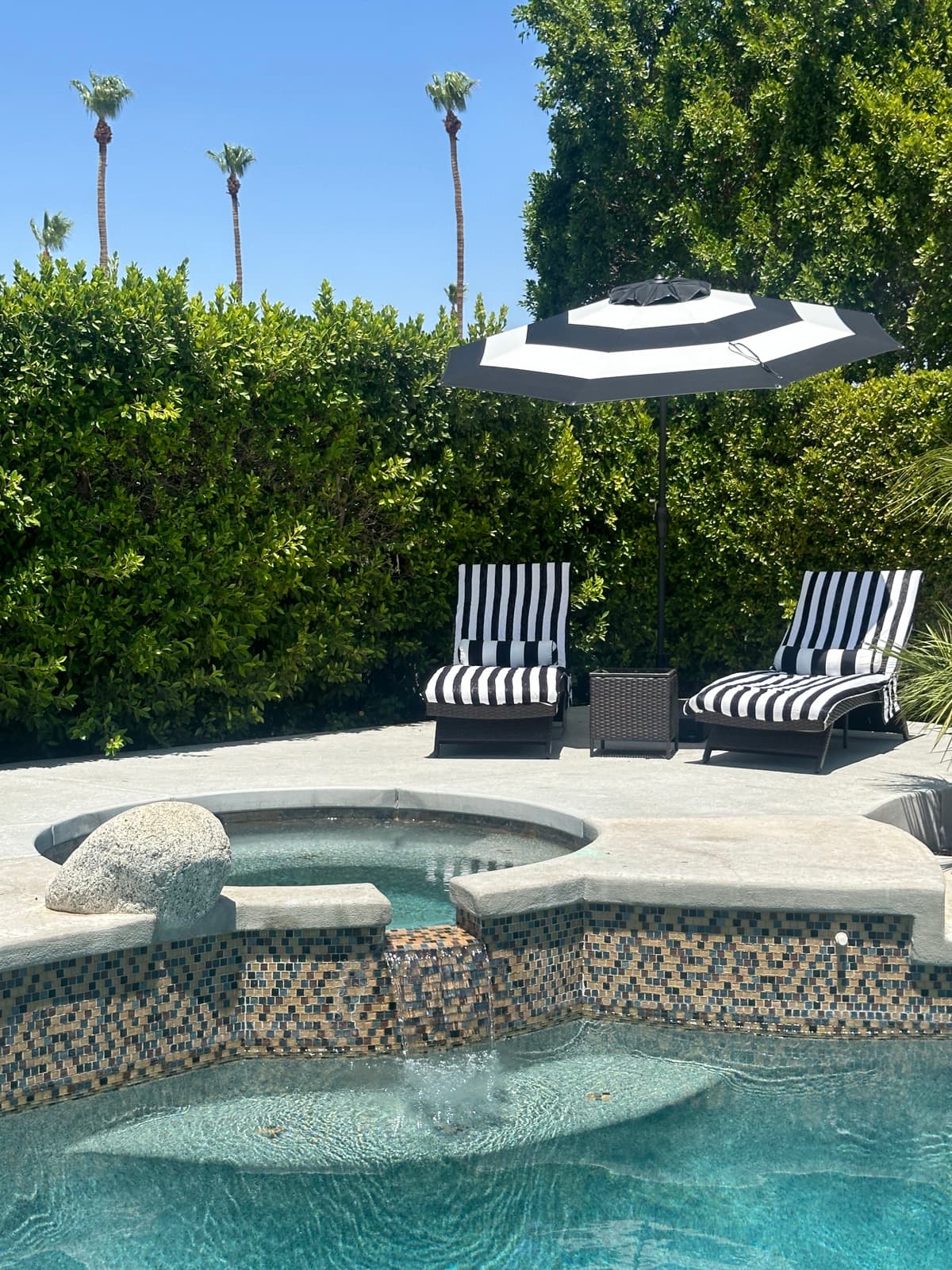 Spa waterfall and striped loungers